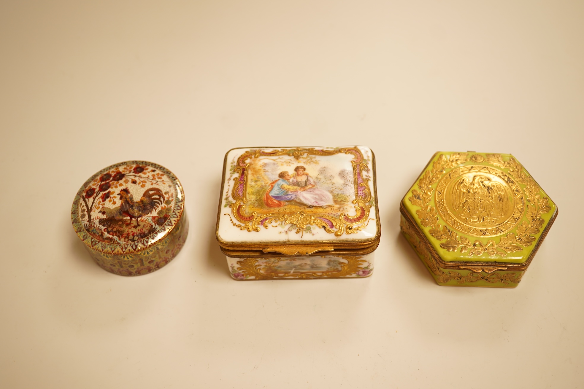 A Zsolnay lustre 'chicken' box and cover and two Sevres style porcelain boxes and covers (3) ‘chicken box’ 5cm diameter.